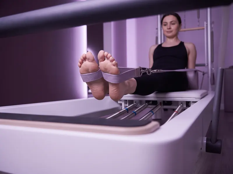 Reformer pilates classes in Limassol: feet in the straps